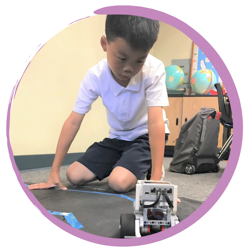 Boy building robotics during afterschool program