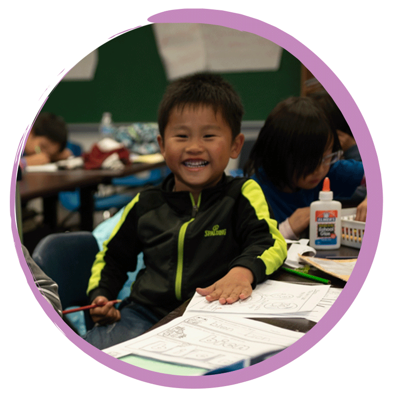 Little boy student smiling during dual language class